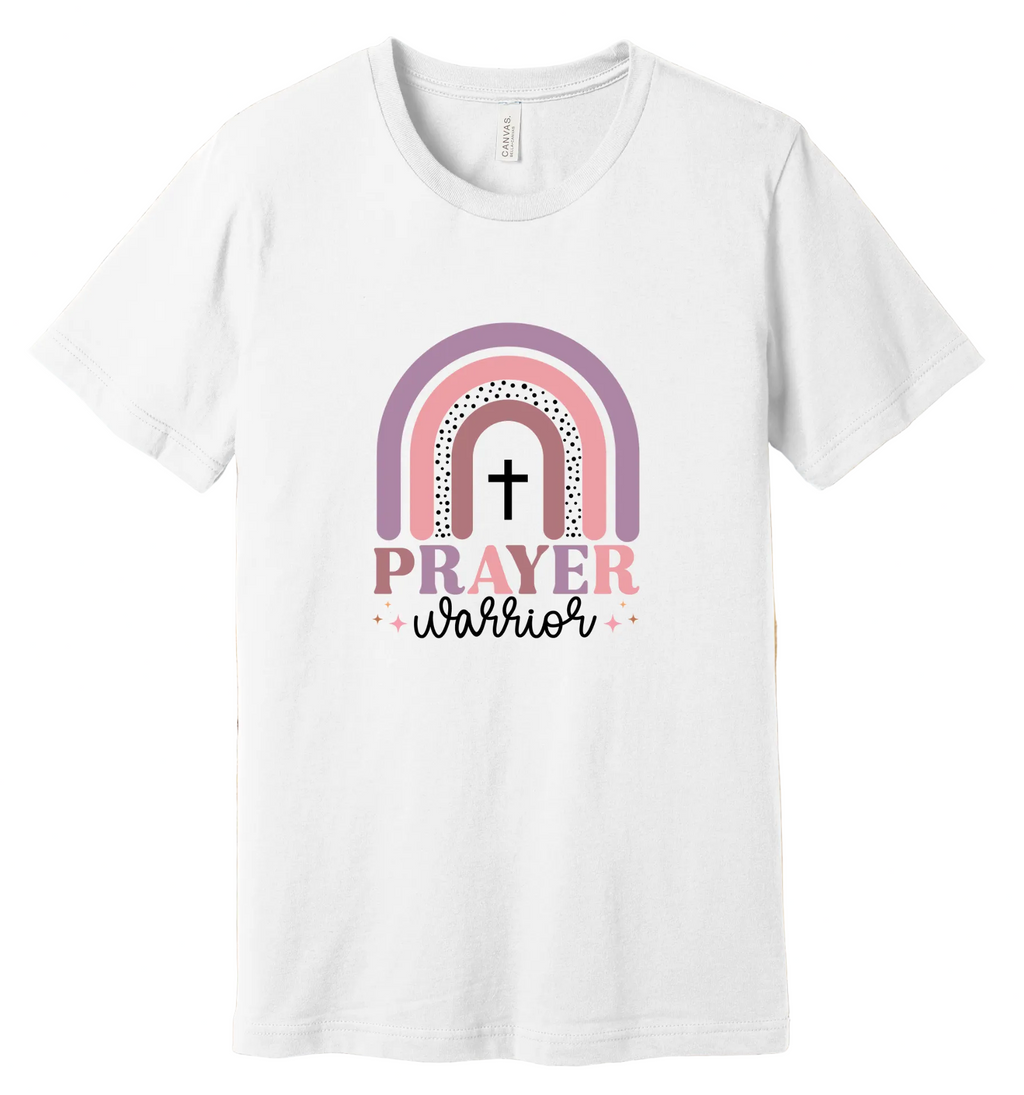 White t-shirt with rainbow and cross design on a wooden background