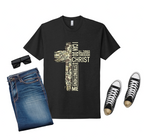 Black t-shirt with cross design and text, blue jeans, black sneakers on a white background