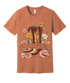Copper t-shirt with cowboy boot and floral design on a wooden background
